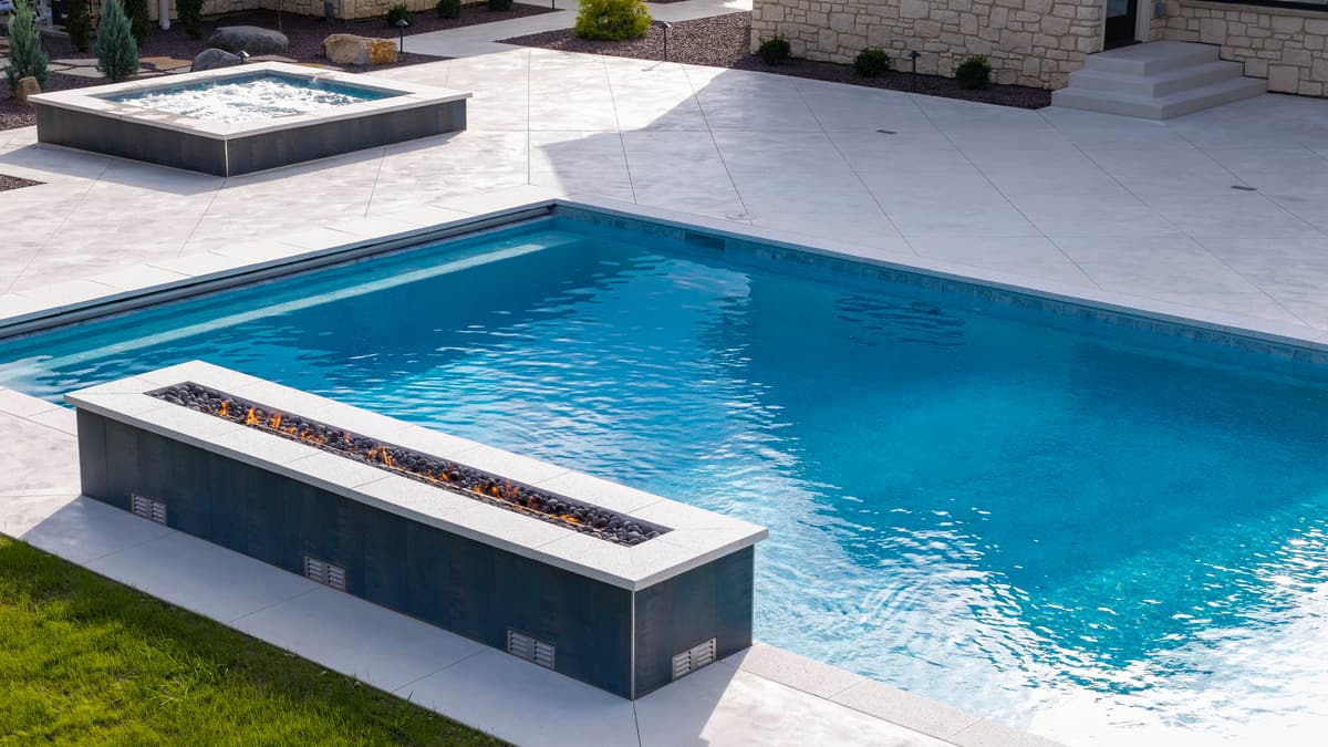 Close view of a raised linear feature set along the edge of a blue gunite pool