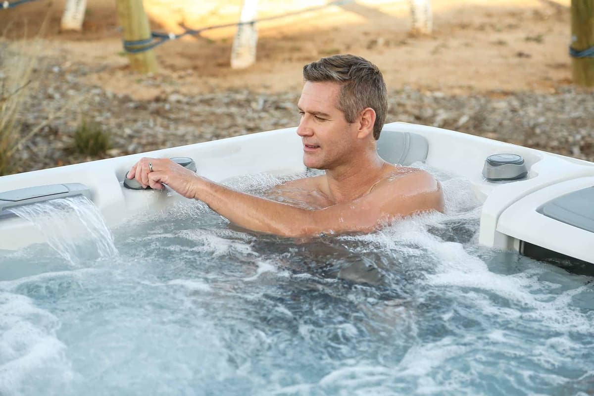 Man relaxing in a Sundance 880 Series hot tub
