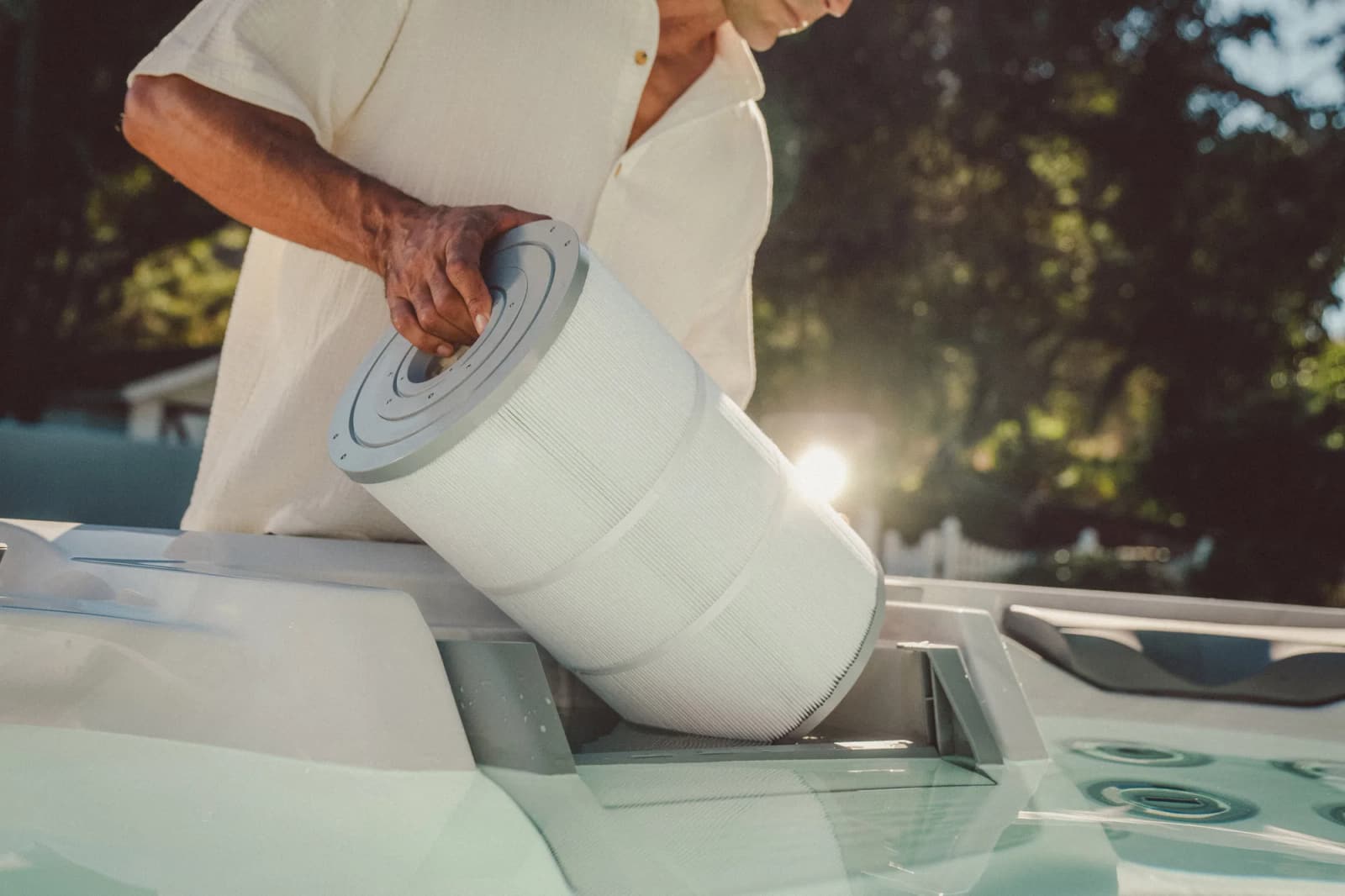 Lifting a filter cartridge out of a Sundance® hot tub